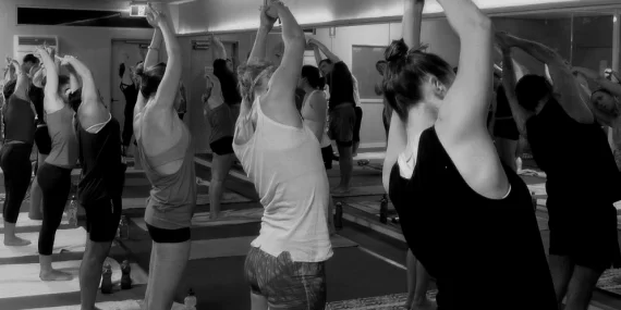 Student practicing Vinyasa Flow at yogafusion studio in Adelaide CBD – building strength and calming the mind